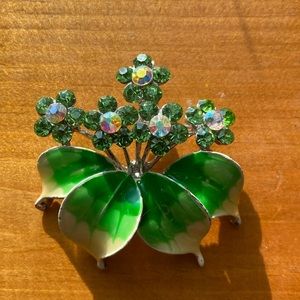 Green, sparkling brooch pin.